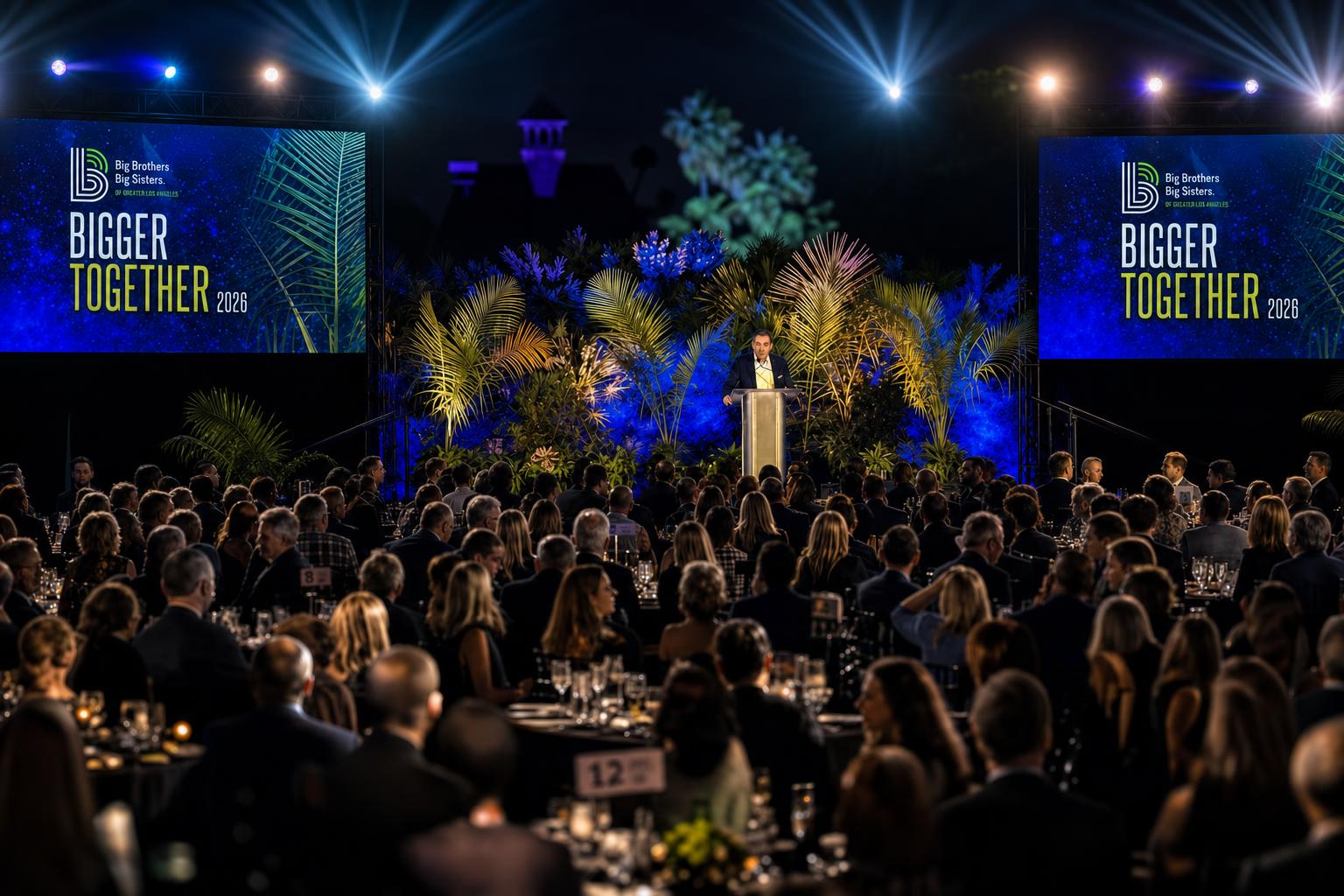 Keynote speaker on stage with polished presentation on a large LED screen