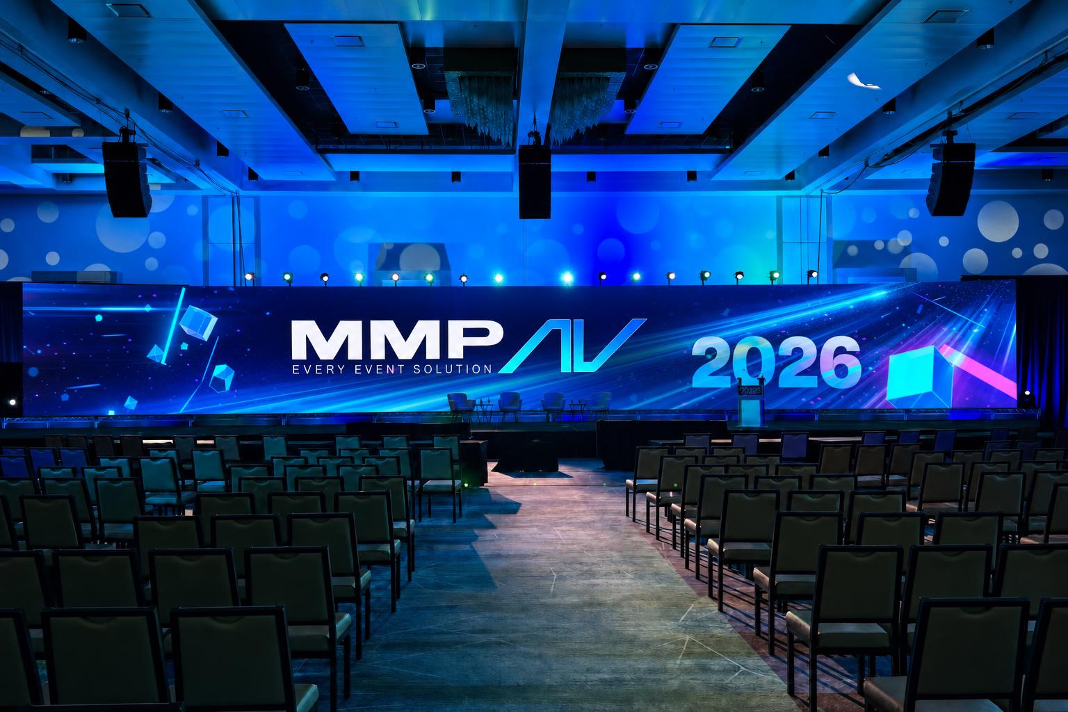 Massive curved LED wall displaying flashy cinematic intro motion graphics in a dramatic blue-lit auditorium